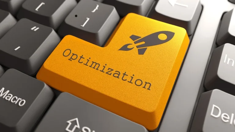 Close-up of a computer keyboard with a bright orange key labeled “Optimization” and a rocket icon, symbolizing digital performance or SEO improvements. Surrounding keys are standard gray keyboard keys, creating contrast with the bold, custom key.